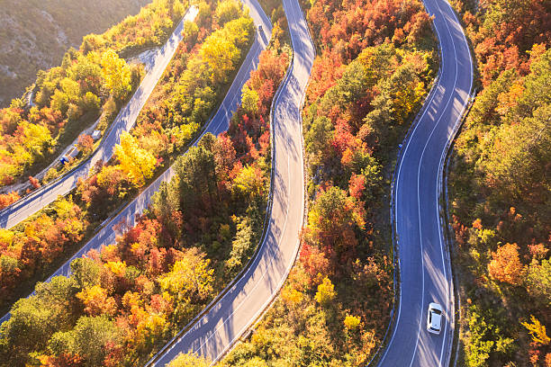 istock Majestic mountain road in autumn at sunset 2243928828
