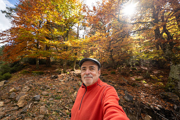 istock Man taking selfie during autumn forest hike 2243930093