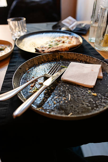 istock Dirty plate with silverware and meal leftovers on restaurant table 2243930482