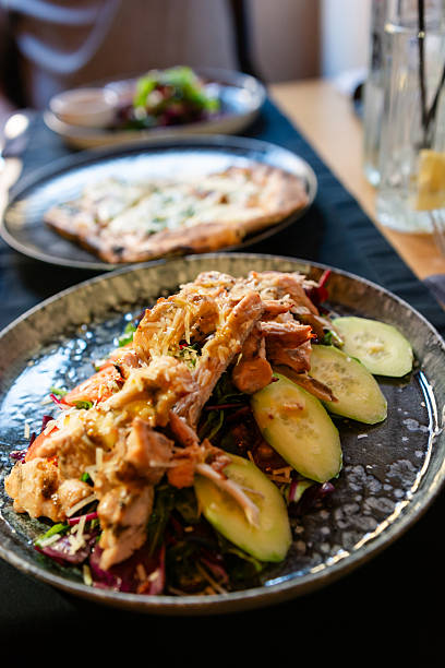 istock Chicken salad with fresh cucumber and greens in restaurant 2243930541