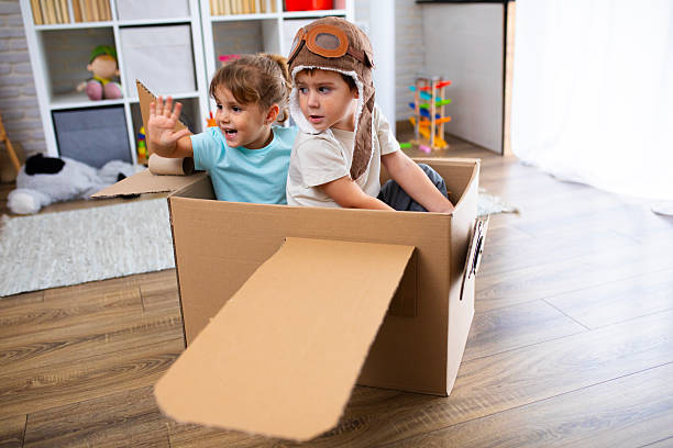 istock Little Pilot and Passenger Playing Together in a Cardboard Airplane 2243930803
