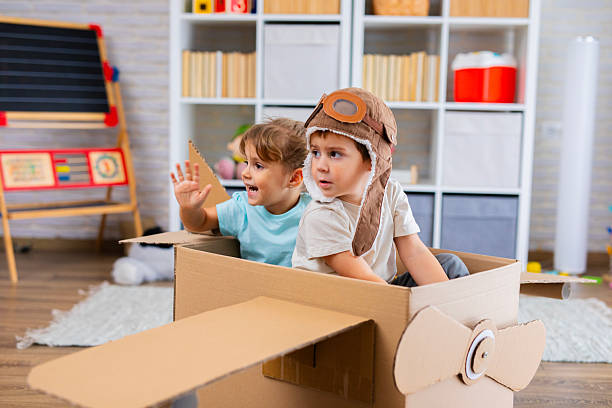istock Little Pilot and Passenger Playing Together in a Cardboard Airplane 2243931504