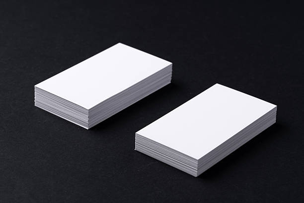istock White blank business cards on dark black background 2243931714