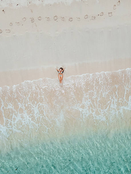 istock Woman Relaxing on Shoreline with Clear Water 2243932990