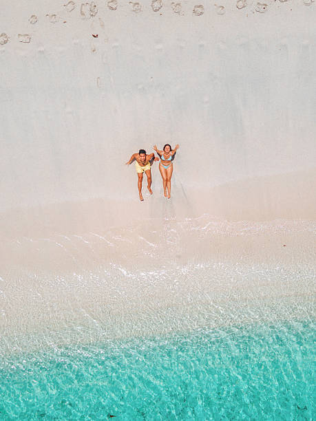 istock Couple Relaxing on White Sandy Beach Shore 2243933002