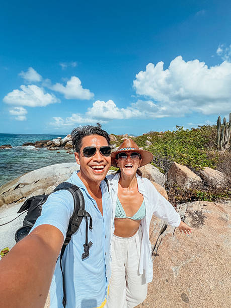 istock Happy Couple Taking Selfie on Rocky Beach 2243933428
