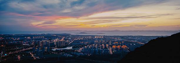 istock Vibrant Sunset Panorama of Coastal Megacity Skyline with Illuminated High-Rises and Distant Horizon 2243934585