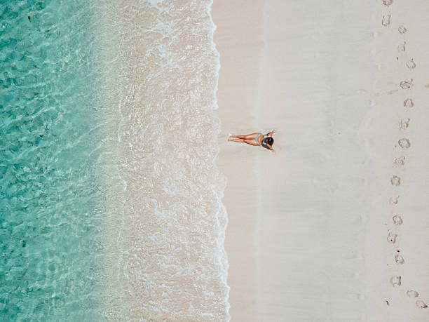 istock Woman Relaxing on Sandy Beach Near Ocean 2243934880