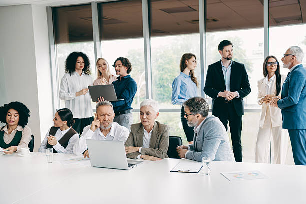 istock Diverse team collaborating in a modern office during a business meeting, focusing on teamwork, communication, and strategy development 2243935404