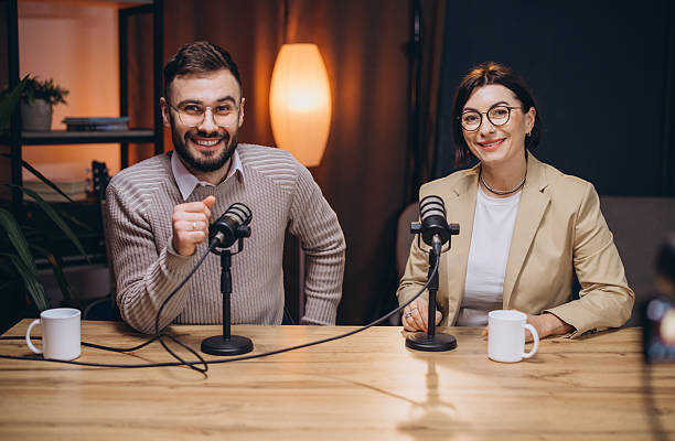 istock Podcasters engaging in lively conversation while recording a new episode in a professional studio filled with advanced audio equipment 2243935481