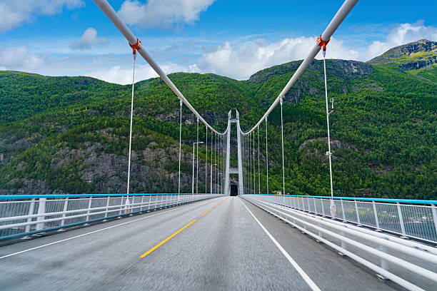 Hardangerbrua suspension bridge over Hardangerfjord Norway in sunny summer travel scenery