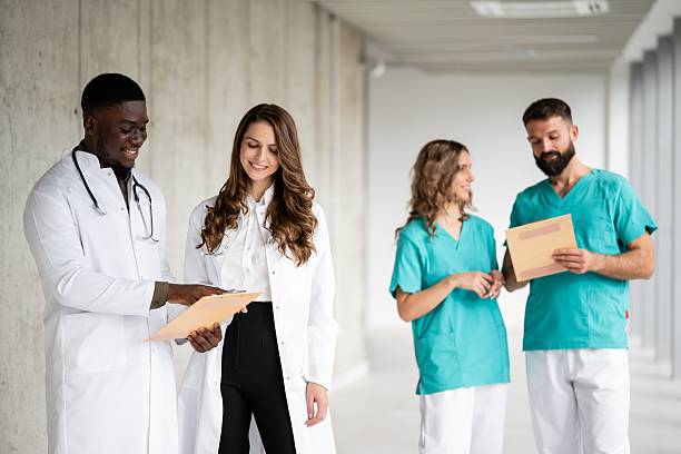 istock Diverse medical team collaborating in hospital hallway 2243936576