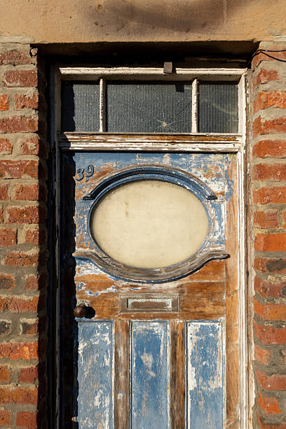 istock Old weathered doorway surrounded by warm brick wall 2243937805