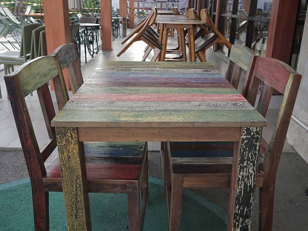 istock Rustic wooden table and chairs featuring a colorful 2243938421
