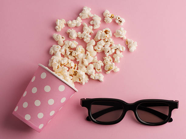 istock Popcorn, cup and 3d glasses on a pastel pink background. 2243941492