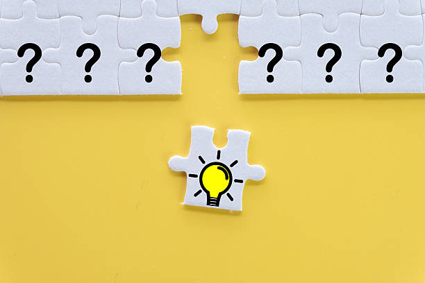 istock Solution and Idea Concept: Lightbulb Puzzle Piece Filling Gap of Questions 2243943522