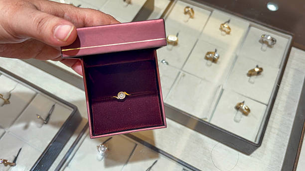 istock gold diamond ring reveal in open ring box 2243944410
