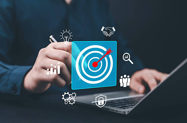 istock Businessman using laptop with digital target icon and business analytics symbols, representing goal achievement, marketing strategy, data analysis, and corporate success symbolizing success, 2243947038