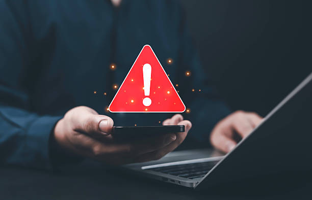 istock Cybersecurity warning alert on smartphone and laptop, symbolizing mobile data breach, phishing attack, malware infection, and online security risk, emphasizing digital safety cyber threat prevention. 2243947342