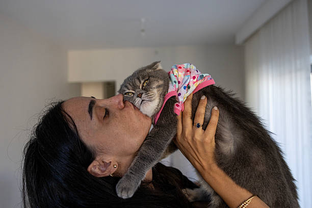 istock woman loving cat 2243948344