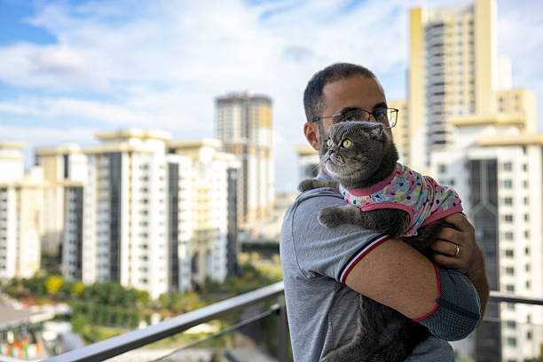 Man Spending Leisure Time with Cat on Balcony