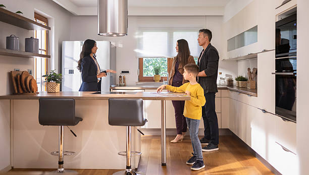 istock Real estate agent showing modern kitchen to couple 2243952056