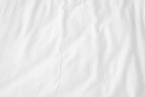 Abstract White Bedding Sheets or White wrinkled fabric background texture and Texture with copy-space :Creased or wrinkled white fabric,Soft focus