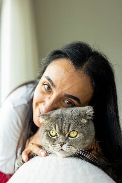 istock woman loving cat 2243954896