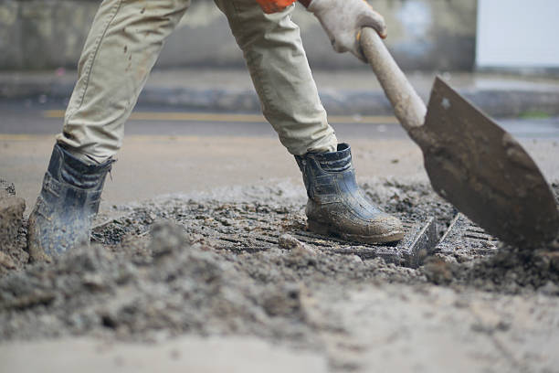 istock Construction worker digs in urban area during daylight hours 2243955052