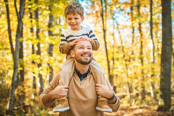 istock father with son in autumn in beautiful forest 2243956769
