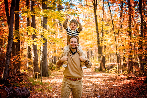 istock father with son in autumn in beautiful forest 2243956770