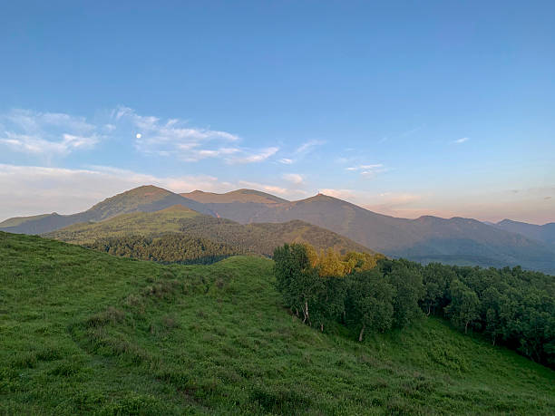 istock Beautiful mountain landscape with green hills and distant peaks under clear sky 2243956773