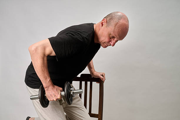 istock Old man in sportwear practice some exercice with dumbbell 2243958641