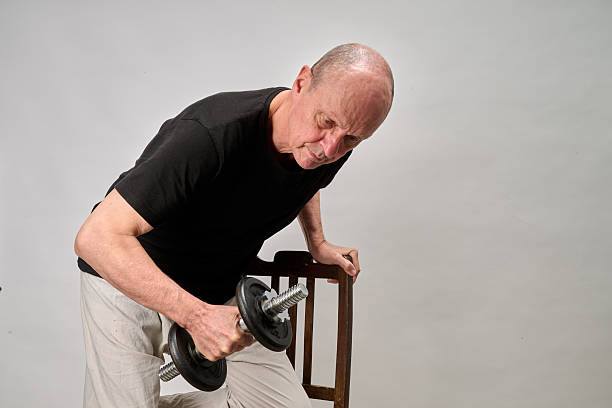 istock Old man in sportwear practice some exercice with dumbbell 2243958642