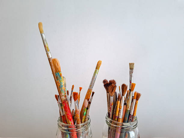 Acrylic paints and art brushes on a white background with copy space for text