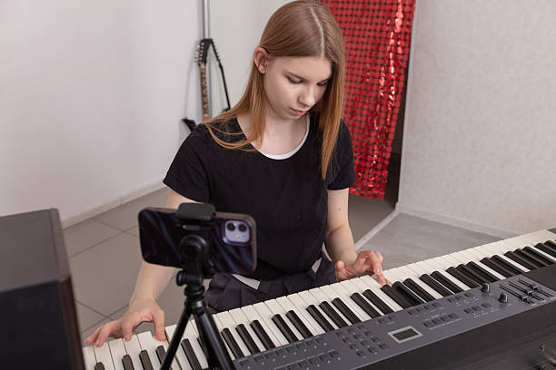 istock Young musician plays keyboard and practices music in a home studio setting during a focused afternoon session 2243959915