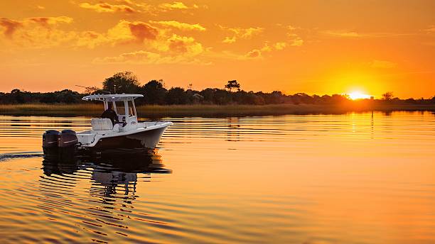 istock Boat cruising at sunset 2243960363