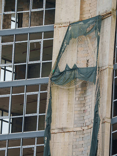 istock Modern Concrete Building Under Construction with Crane and Hoist 2243960747