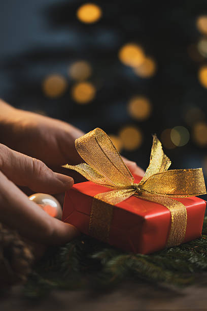 istock Man holding Christmas gift in hands 2243961590