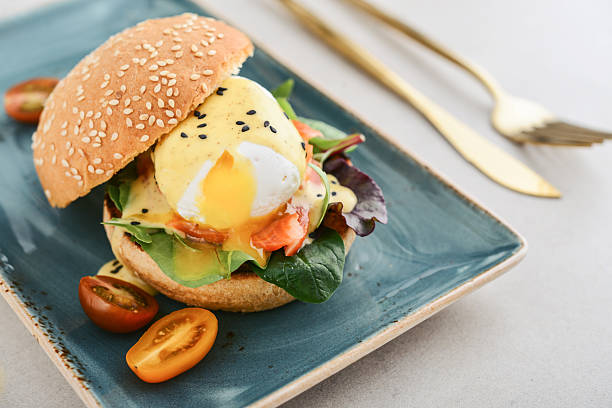 istock Eggs Benedict with salad leafs, salmon and fresh cherry tomato 2243963347