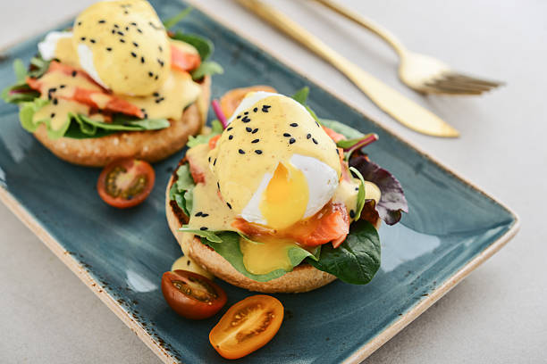 istock Eggs Benedict with salad leafs, salmon and fresh cherry tomato 2243963385