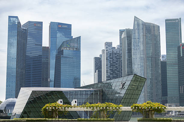 24 October 2025, Downtown core - Singapore.Set against the shimmering skyline of Singapore’s Downtown Core, the Louis Vuitton Island Maison stands as a sculptural icon on Marina Bay. The interplay between the boutique’s glass architecture and the city’s soaring towers captures Singapore’s spirit of modern luxury and design innovation.