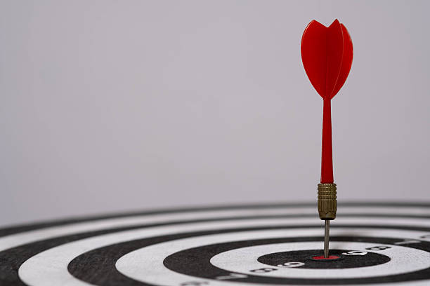 istock Close-up of red dart hitting bullseye on dartboard, representing precision, focus, target achievement, strategic success, and goal-setting in business or personal life. 2243965890