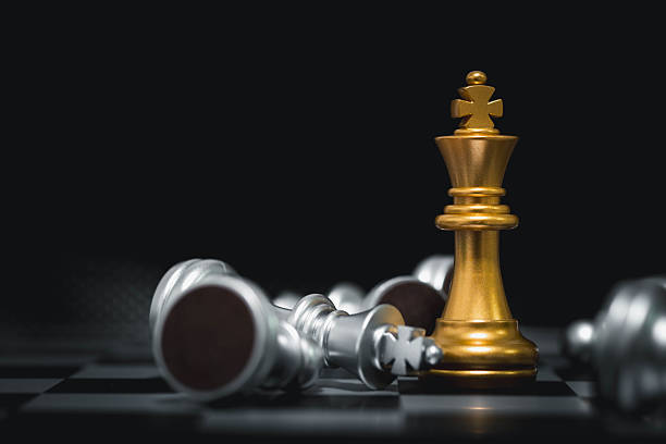 istock Golden king chess piece standing victorious among fallen silver pieces, symbolizing success, dominance, leadership, competition, business victory, strategy, and overcoming challenges. 2243966049