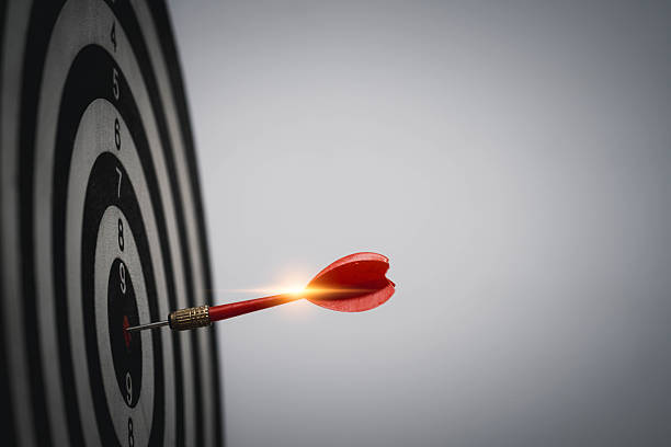 istock Red dart hitting bullseye with glowing light flare symbolizes powerful focus, strategic success, precise goal achievement, business breakthrough, and inspirational momentum. 2243966797