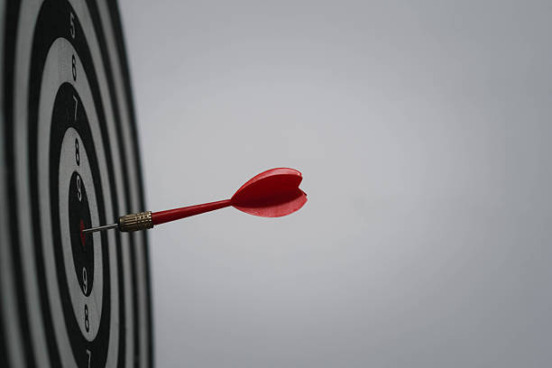 istock Side view of red dart hitting bullseye on target board symbolizes precision, clear goal setting, accuracy, business strategy, and achievement in personal or professional success. 2243966813