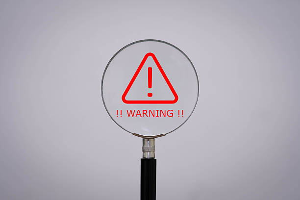 istock Magnifying glass highlighting a red warning symbol with exclamation mark, representing alert, caution, or risk. Ideal for cybersecurity, safety, and critical messages. 2243966826