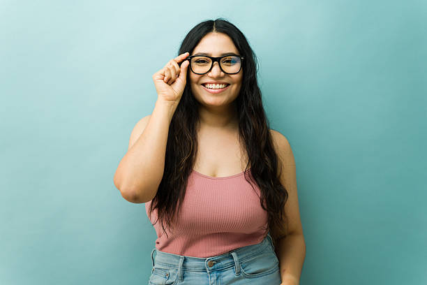 istock Happy young woman adjusting framed eyeglasses smiling cheerfully 2243966987