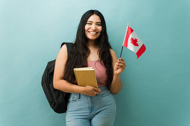 istock Female Latin student holding books and canada flag 2243967194