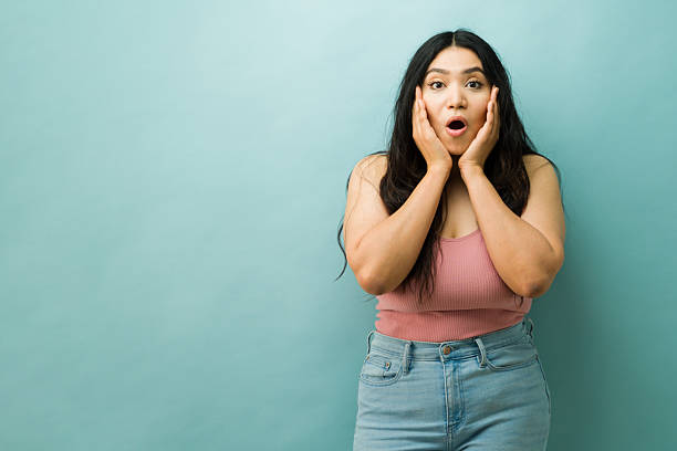 istock Young woman showing surprised and shocked expression 2243967282